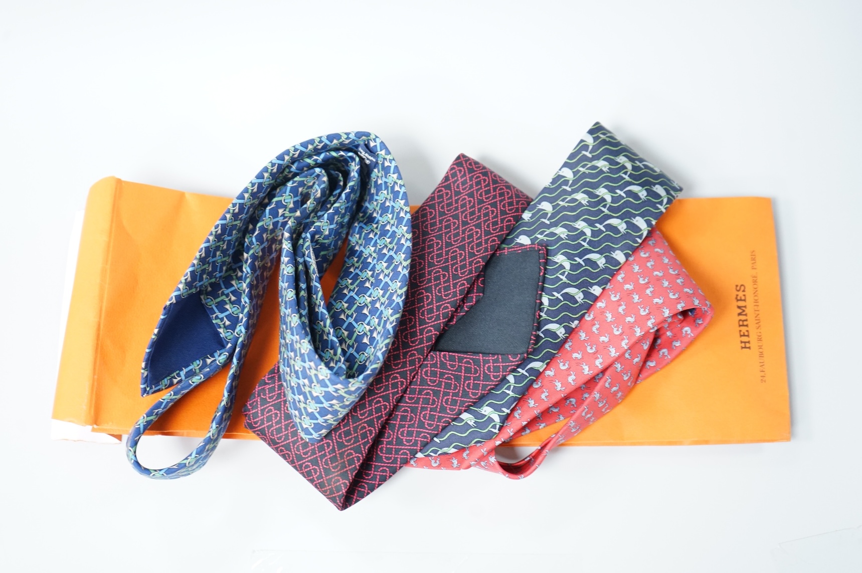 Two boxed Hermes silk scarves comprising ‘Real Escuela Andaluza del Arte Equestre’ and ‘Equateur’, with original boxes, together with four Hermes gentleman’s silk ties